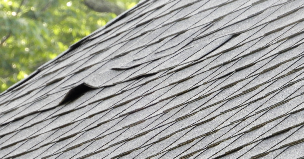 Small shingle damage on a roof, that leads to the need for repair.